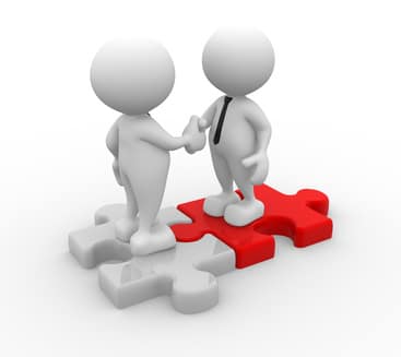 3d people - men, person shaking hands on puzzle pieces. The concept of business partners